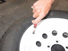 Picture of removing the valve core from the tire