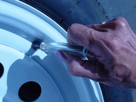 Attaching the clear plastic hose to the valve stem